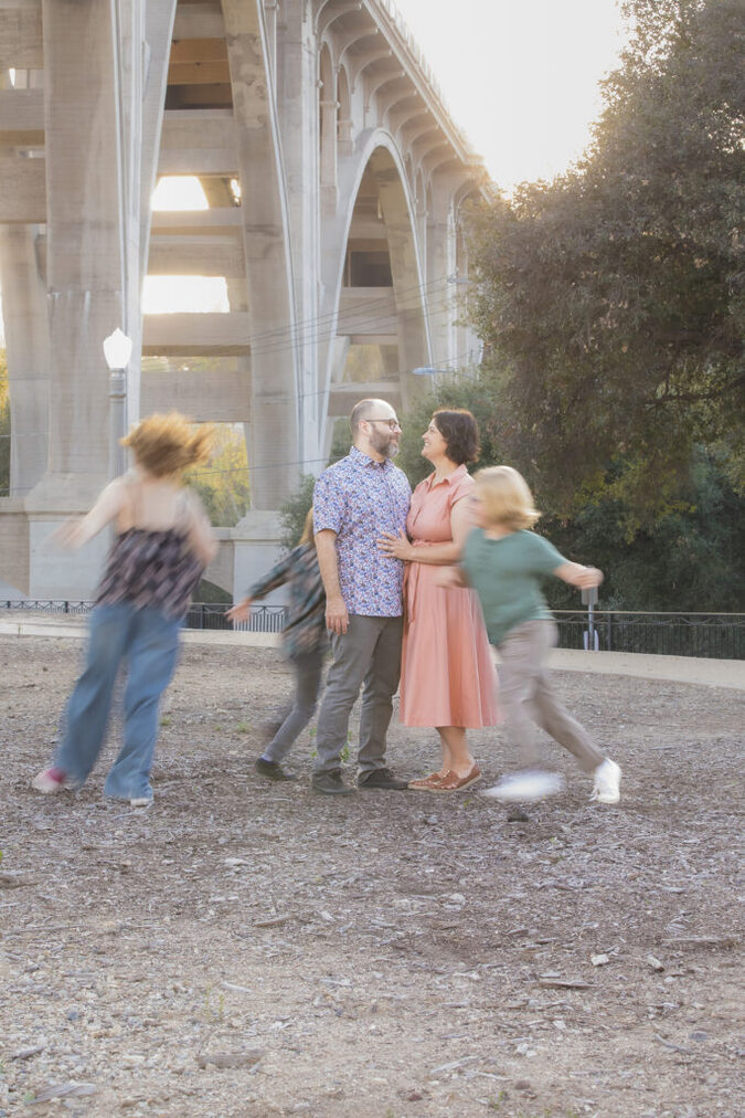 Candid outdoor family portrait with genuine laughter during a natural light session in Pasadena.